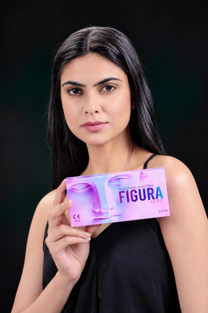 Model holding a box of Figura Light hyaluronic acid dermal filler